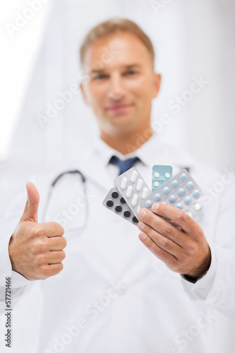 Photo: male doctor with packs of pills male doctor with packs of pills