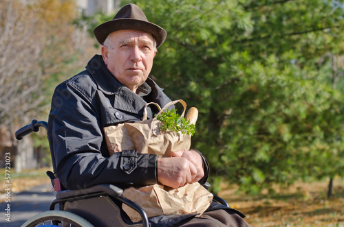 Photo: Handicapped man doing his grocery shopping Handicapped man doing his grocery shopping
