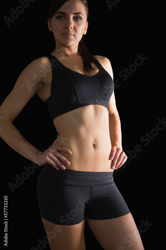 Photo: Sporty slender woman posing in sportswear with hands on hips Sporty slender woman posing in sportswear with hands on hips