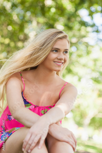 Photo: Lovely content woman relaxing on a lawn Lovely content woman relaxing on a lawn