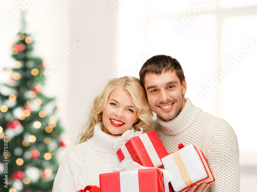 Photo: smiling woman and man with gift box smiling woman and man with gift box