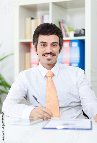 Photo: Smiling businessman in the office Smiling businessman in the office