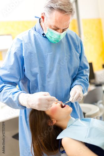 Photo: Dentist doing a treatment in his studio Dentist doing a treatment in his studio