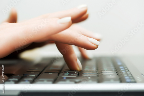 Photo: Female hands typing on computer keyboard Female hands typing on computer keyboard