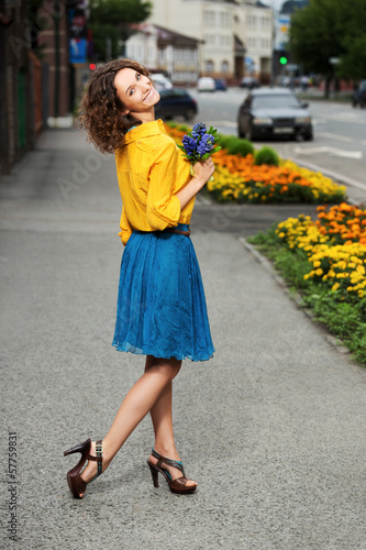 Photo: Happy young woman with bouquet of flowers Happy young woman with bouquet of flowers