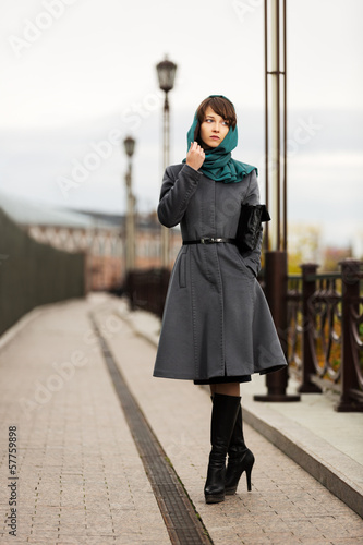 Photo: Sad young woman in grey classic coat with a handbag Sad young woman in grey classic coat with a handbag