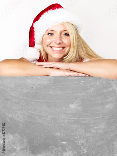 Photo: Women with santa hat presenting message board Women with santa hat presenting message board