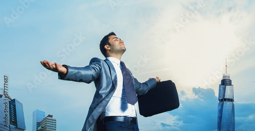 Photo: Successful businessman with arms outstretched celebrating succes Successful businessman with arms outstretched celebrating succes