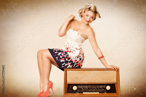 Photo: lachendes Pin up Girl sitzt auf Radio lachendes Pin up Girl sitzt auf Radio