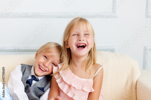Photo: Brother and sister are sitting on the sofa Brother and sister are sitting on the sofa
