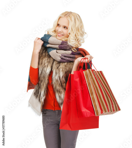 Photo: teenage girl in winter clothes with shopping bags teenage girl in winter clothes with shopping bags