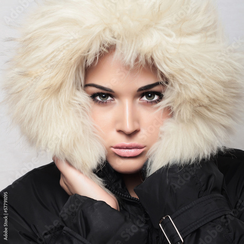 Photo: Beautiful woman with fur. white hood. winter style.make-up Beautiful woman with fur. white hood. winter style.make-up