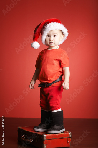 Photo: little cute boy with christmas suitcase little cute boy with christmas suitcase