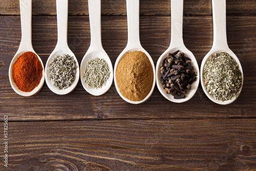 Photo: Spice assortment on a wooden table Spice assortment on a wooden table