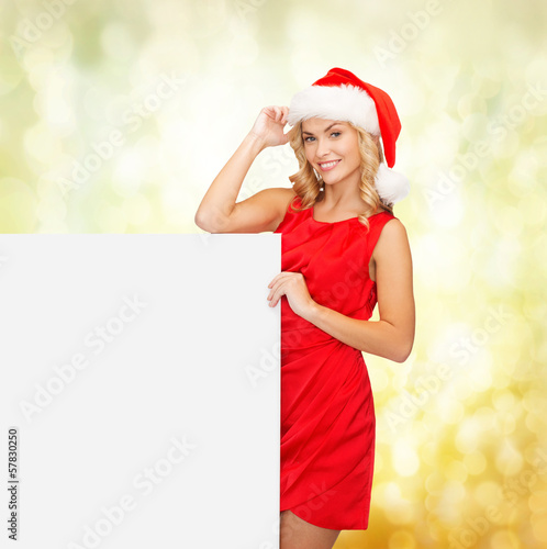 Photo: woman in santa helper hat with blank white board woman in santa helper hat with blank white board