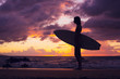 Beautiful sexy young surfer girl in bikini on the beach at sunse Beautiful sexy young surfer girl in bikini on the beach at sunse