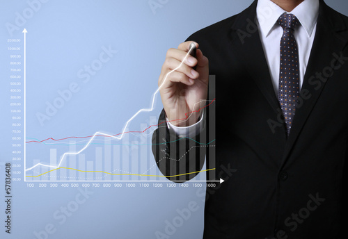 Photo: Business man hand drawing graph Business man hand drawing graph