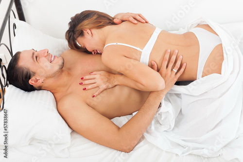 Photo: Smiling lovers in bed Smiling lovers in bed