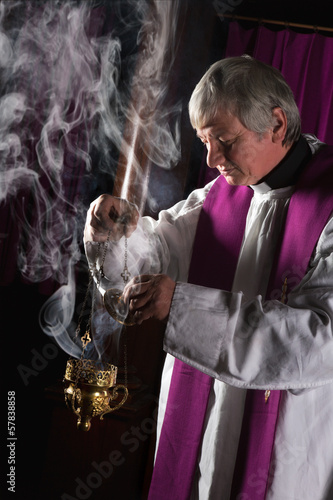 Photo: Incense burner and priest Incense burner and priest