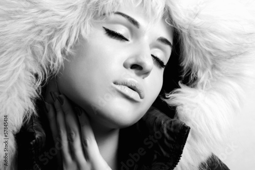 Photo: beautiful woman with fur. white fur hood.monochrome beautiful woman with fur. white fur hood.monochrome