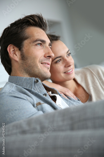 Photo: Couple at home relaxing in sofa Couple at home relaxing in sofa