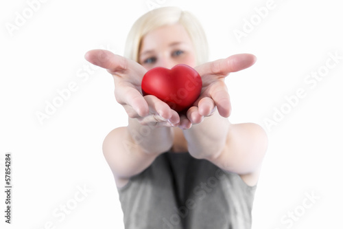 Photo: Woman presenting red heart Woman presenting red heart