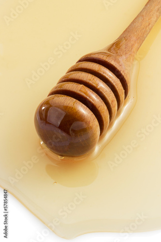 Photo: honey and stick on white honey and stick on white