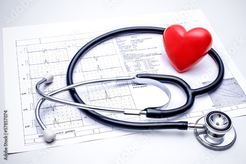 Photo: Stethoscope with a heart lying on ECG diagram Stethoscope with a heart lying on ECG diagram