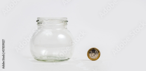 Photo: Euro coin by empty jar Euro coin by empty jar
