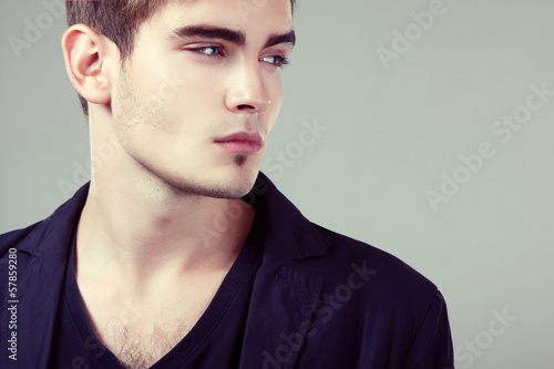 Photo: Young man handsome face closeup, sexy guy looking at camera Young man handsome face closeup, sexy guy looking at camera