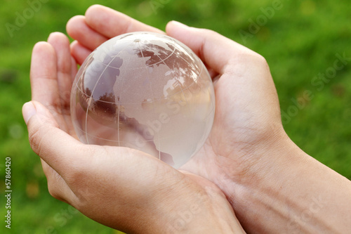 Photo: Hands holding a glass globe Hands holding a glass globe