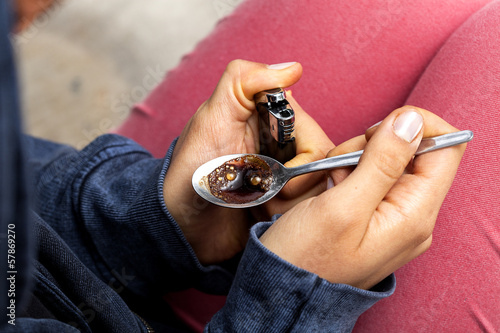 Photo: Junkie preparing a dose of heroin Junkie preparing a dose of heroin