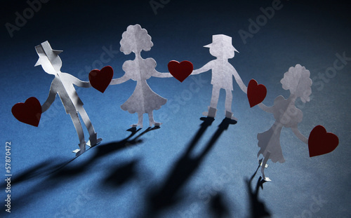Photo: Paper people in social network concept on dark background Paper people in social network concept on dark background