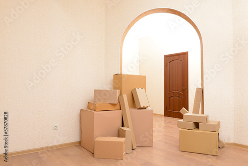 Photo: Empty room with stack of cartons: moving house concept Empty room with stack of cartons: moving house concept