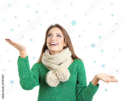 Photo: Beautiful smiling girl in warm knit scarf isolated on white Beautiful smiling girl in warm knit scarf isolated on white