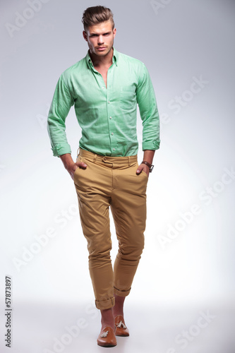 Photo: casual man walking toward the camera with hands in pockets casual man walking toward the camera with hands in pockets