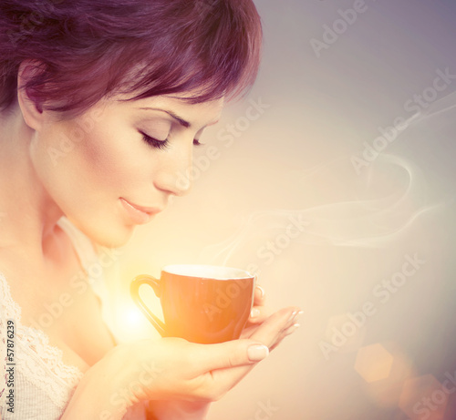 Photo: Beautiful Girl Enjoying Coffee. Woman with Cup of Hot Beverage Beautiful Girl Enjoying Coffee. Woman with Cup of Hot Beverage
