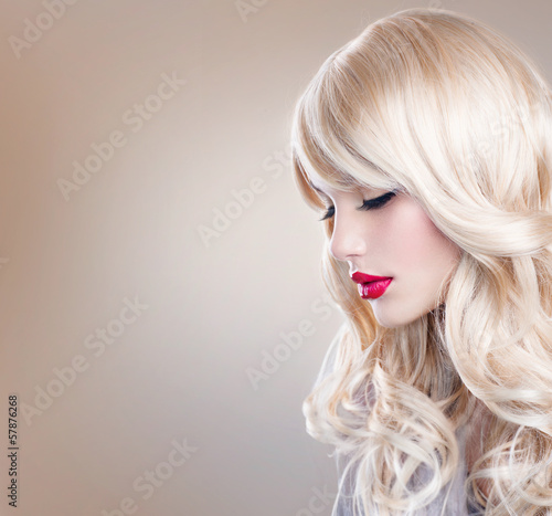 Photo: Blonde Woman Portrait. Beautiful Blond Girl with Long Wavy Hair Blonde Woman Portrait. Beautiful Blond Girl with Long Wavy Hair