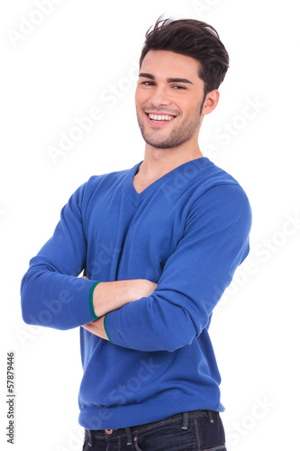 Photo: casual young man standing with his hands crossed casual young man standing with his hands crossed