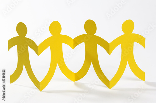 Photo: yellow paper people in a row yellow paper people in a row