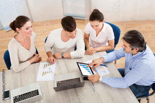 Photo: Business Team In Office Meeting Business Team In Office Meeting