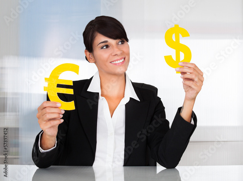 Photo: Businesswoman With Euro And Dollar Sign Businesswoman With Euro And Dollar Sign
