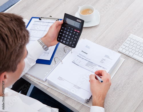 Photo: Businessman Using Calculator Businessman Using Calculator