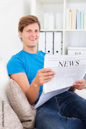 Photo: Young Man Reading Newspaper Young Man Reading Newspaper