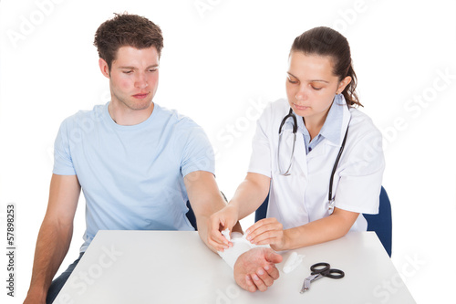 Photo: Doctor Bandaging Patient Doctor Bandaging Patient