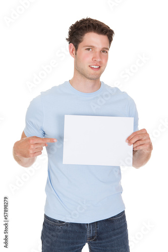 Photo: Happy Young Man Holding Blank Placard Happy Young Man Holding Blank Placard
