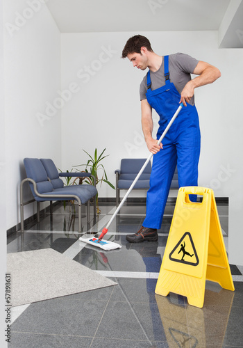 Photo: Man Cleaning The Floor Man Cleaning The Floor