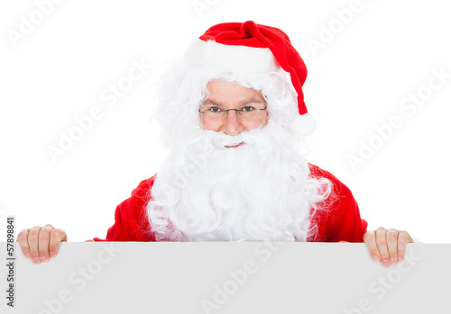 Photo: Portrait of a santa holding blank placard Portrait of a santa holding blank placard