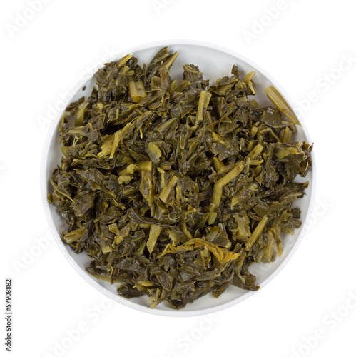Photo: A bowl of collard greens on a white background A bowl of collard greens on a white background