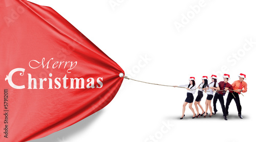 Photo: Asian Business team pull christmas banner Asian Business team pull christmas banner